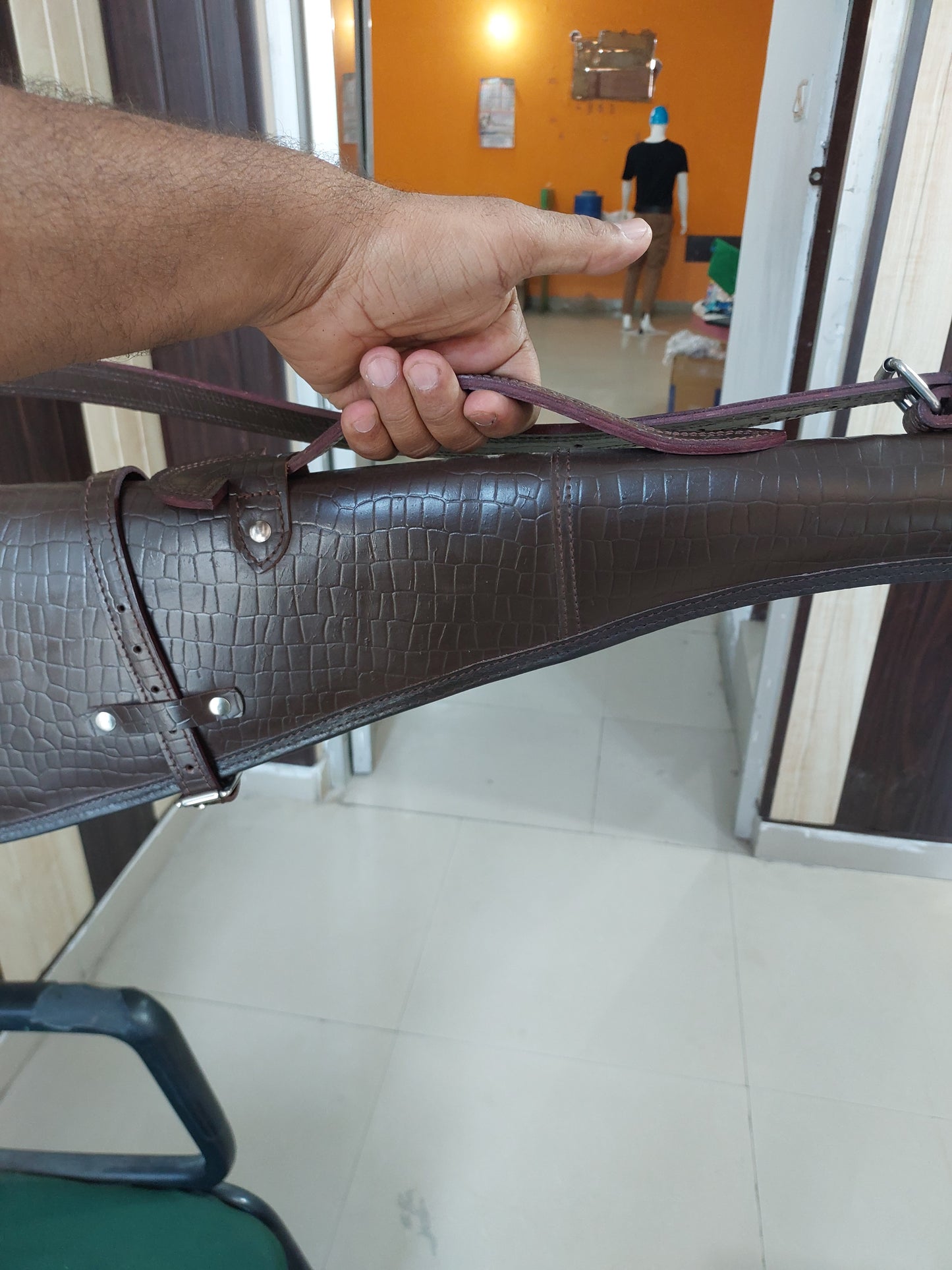 33 inch croc embossed leather rifle scabbard with adjustable strap
Rifle case mounted on wooden wall – western leather design
Inside view of fleece-lined gun scabbard
Full-length view of rifle scabbard with stainless hardware
Leather scabbard displayed on floor – cowboy style
Zoom-in of croc leather pattern with hook and buckle
Hand-holding leather rifle scabbard – easy grip
Informative banner for croc leather scabbard – genuine leather, stainless hardware
Rifle inside scabbard – ammo loop visible