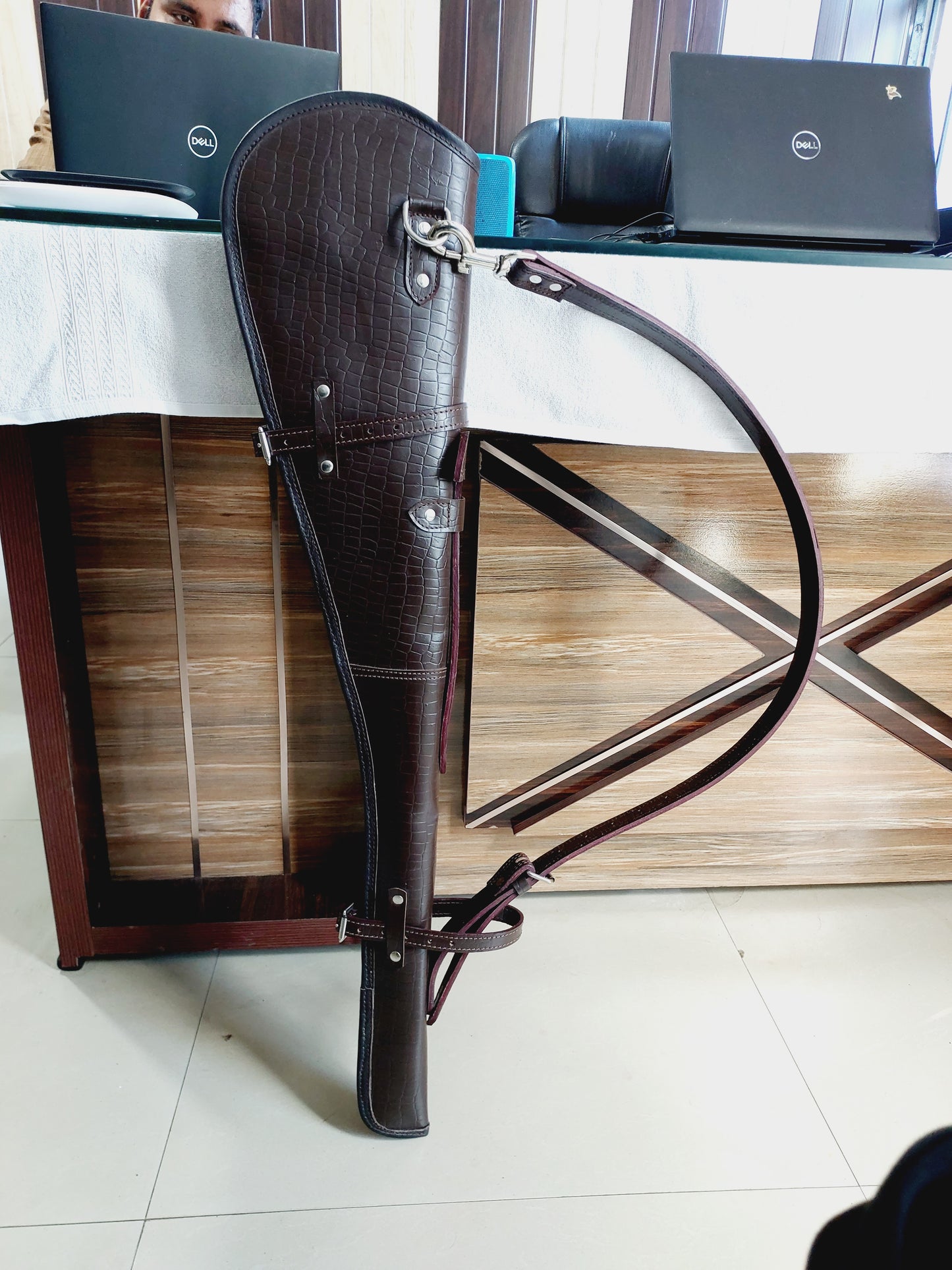 33 inch croc embossed leather rifle scabbard with adjustable strap

Rifle case mounted on wooden wall – western leather design

Inside view of fleece-lined gun scabbard

Full-length view of rifle scabbard with stainless hardware

Leather scabbard displayed on floor – cowboy style

Zoom-in of croc leather pattern with hook and buckle

Hand-holding leather rifle scabbard – easy grip

Informative banner for croc leather scabbard – genuine leather, stainless hardware

Rifle inside scabbard – ammo loop visible