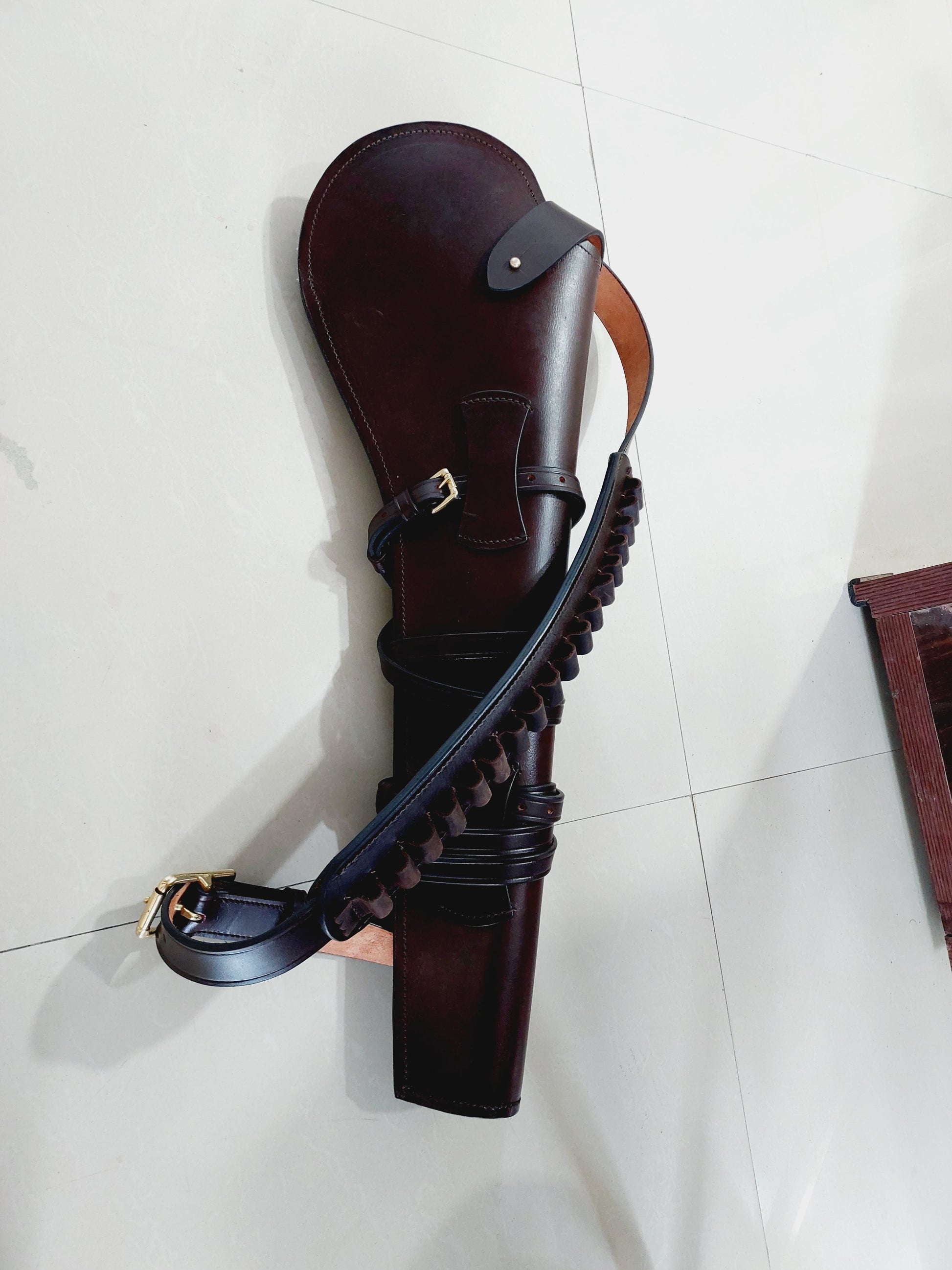 Brown 22 inch rifle scabbard with shoulder strap on outdoor surface

Rifle case measurements: 22" long, 8" top width, 3.5" bottom width

Rifle scabbard with attached ammo loop and adjustable sling
