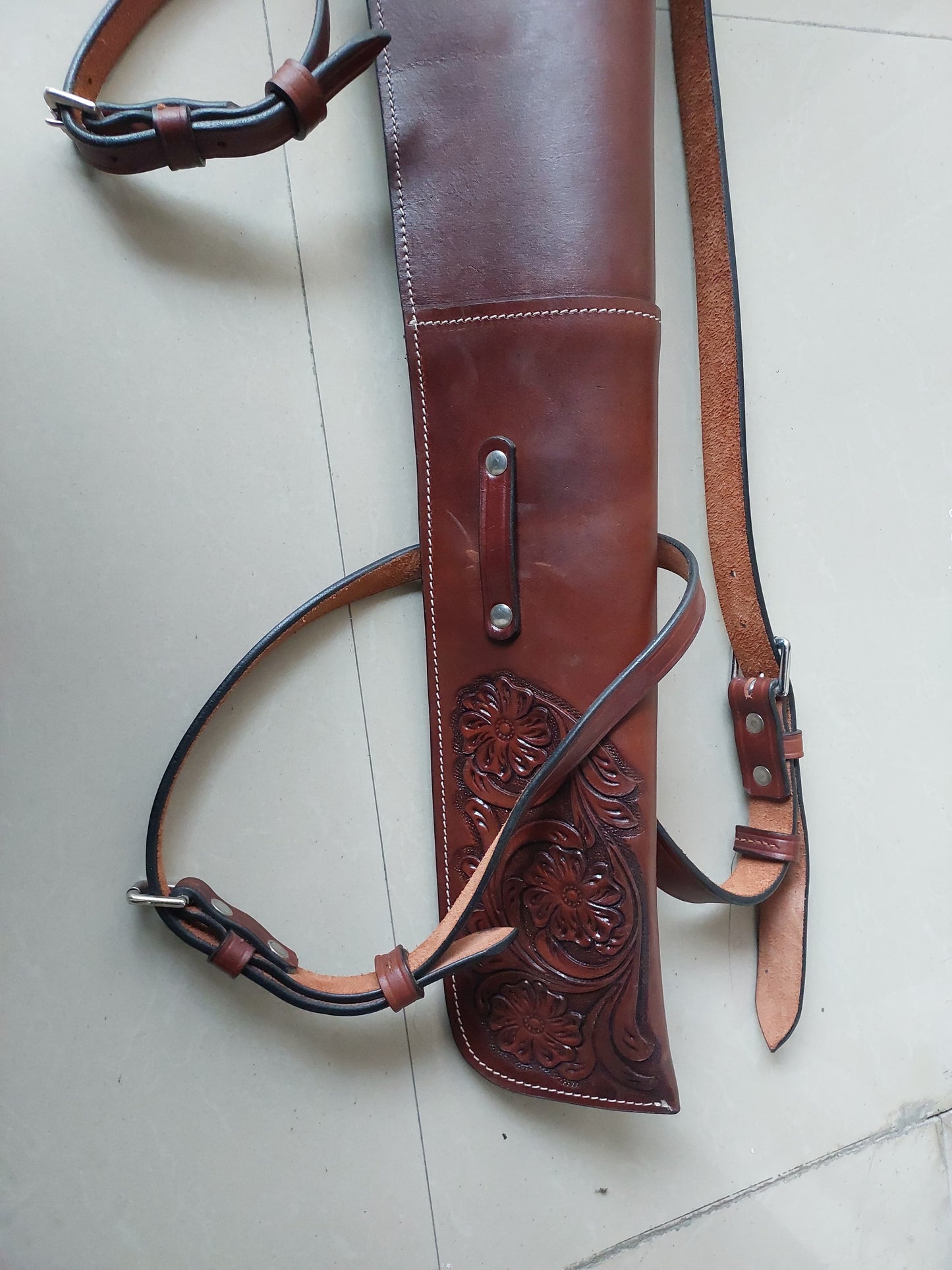Hand-tooled leather rifle scabbard 33 inch long

Western leather gun cover with adjustable straps

Full grain leather rifle case for lever action rifles

Cowboy-style rifle scabbard for Marlin and Henry

Floral carved rifle cover with buckle flap

Handmade brown leather gun case for saddle mount