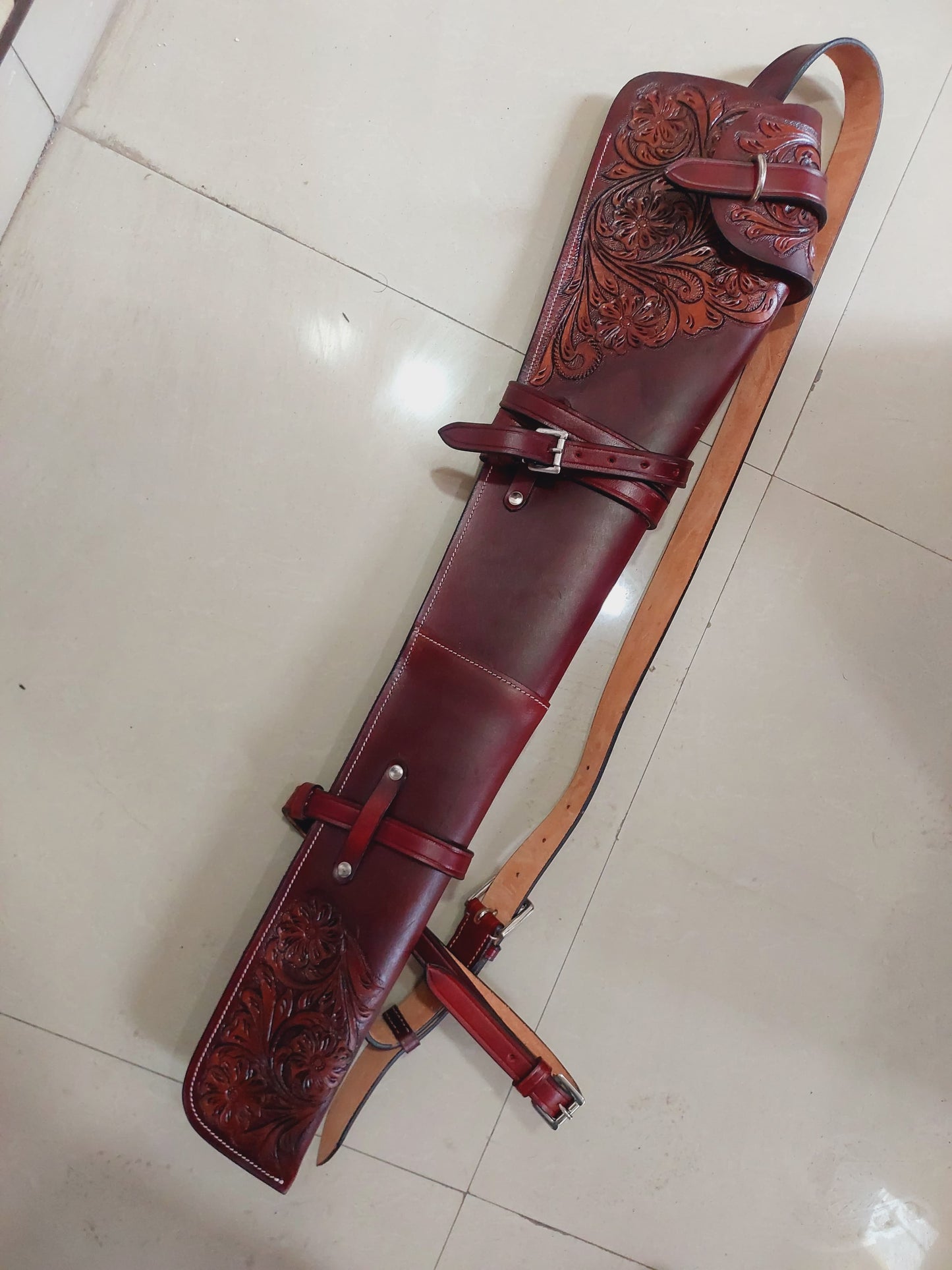 Hand-tooled leather rifle scabbard 33 inch long

Western leather gun cover with adjustable straps

Full grain leather rifle case for lever action rifles

Cowboy-style rifle scabbard for Marlin and Henry

Floral carved rifle cover with buckle flap

Handmade brown leather gun case for saddle mount