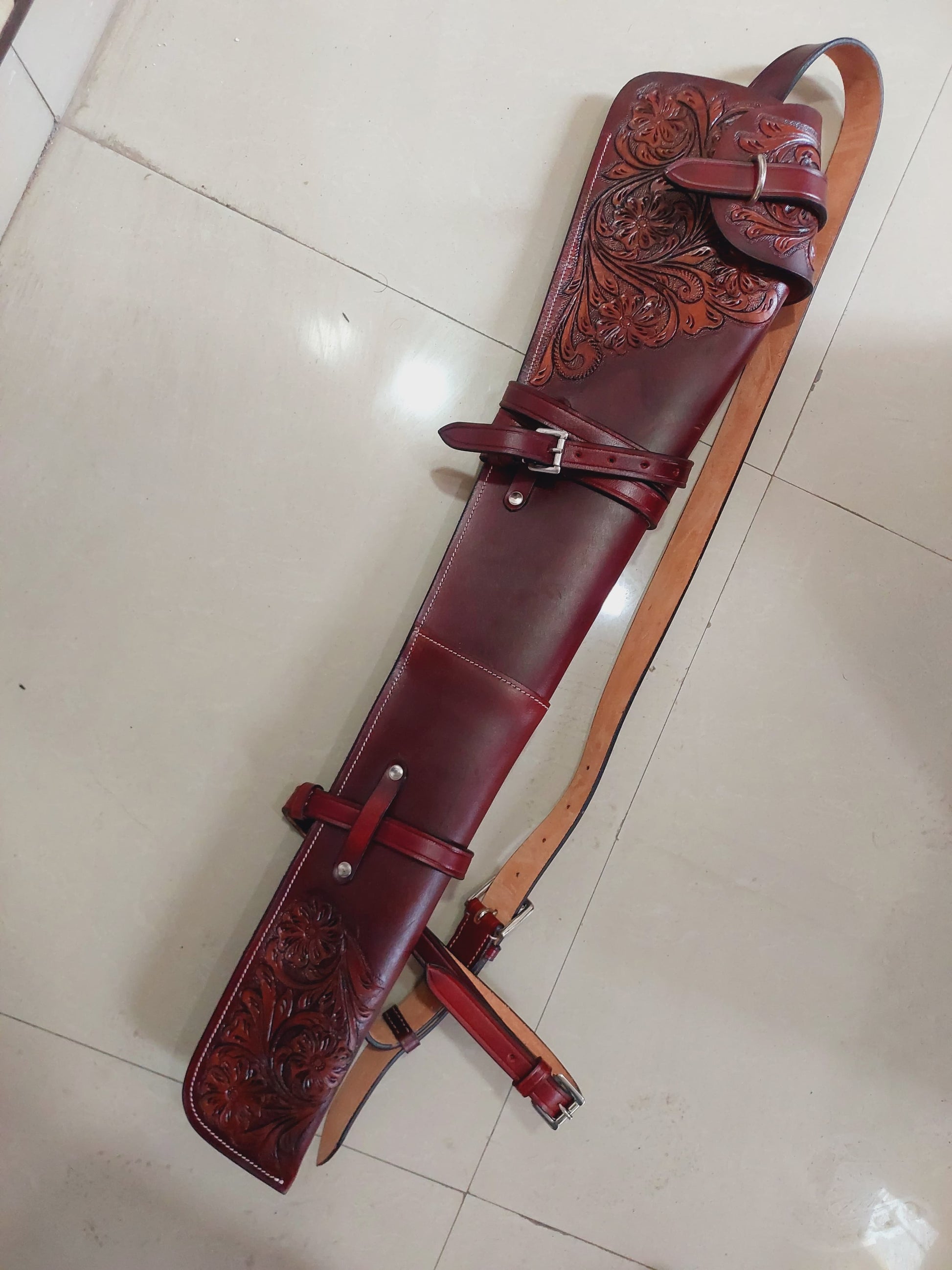 Hand-tooled leather rifle scabbard 33 inch long

Western leather gun cover with adjustable straps

Full grain leather rifle case for lever action rifles

Cowboy-style rifle scabbard for Marlin and Henry

Floral carved rifle cover with buckle flap

Handmade brown leather gun case for saddle mount